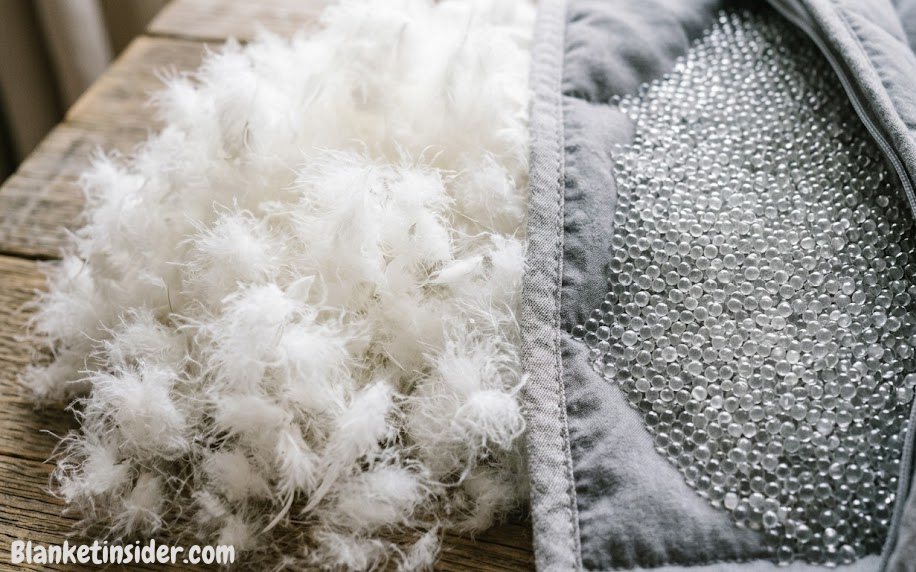 Close-up of fluffy down blanket fill next to weighted blanket glass bead fill